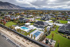 Aerial perspective of suburban area with a pool and mountains