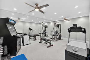 Exercise area with recessed lighting, ceiling fan, and light colored carpet