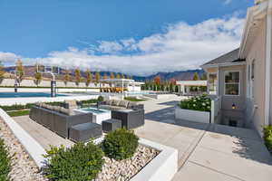 View of home's community with an outdoor living space with a fire pit, a patio, a mountain view, and a swimming pool