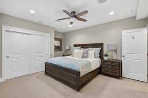 Bedroom featuring light colored carpet, recessed lighting, a ceiling fan, and a closet