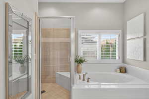 Full bathroom featuring a garden tub and a stall shower