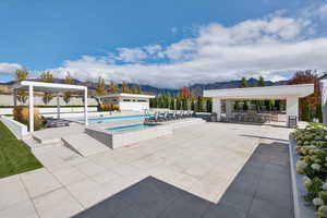 View of swimming pool with a patio area and a mountain view