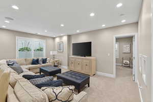 Basement Living room with light carpet and recessed lighting