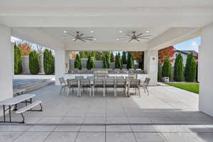 View of patio with outdoor dining area, a ceiling fan, and exterior kitchen