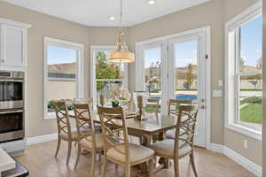 Dining area featuring light wood-style flooring, a mountain view, and recessed lighting