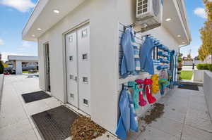 View of exterior entry featuring stucco siding and a community pool