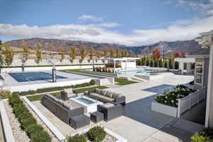 Surrounding community with a patio, a swimming pool, an outdoor living space with a fire pit, and a mountain view