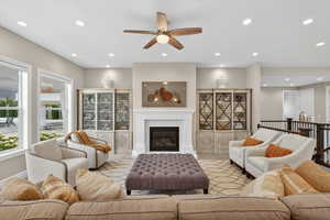 Living area featuring a tile fireplace, recessed lighting, and a ceiling fan