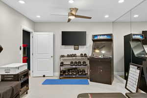Exercise area with recessed lighting and a ceiling fan