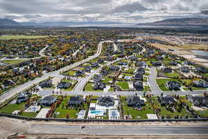 Aerial overview of property's location featuring nearby suburban area and a mountainous background