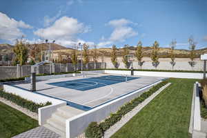 View of basketball court with community basketball court, a mountain view, and a patio area