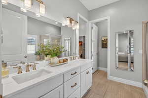 Full bath with plenty of natural light, double vanity, a stall shower, and connected bathroom