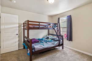 Bedroom with carpet flooring and a textured ceiling