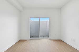 Living room featuring light wood-style floors and baseboards