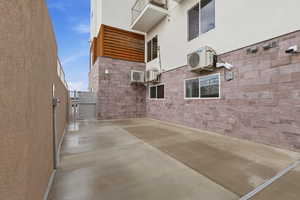 View of Sun Deck featuring a gate, a patio, and stucco siding