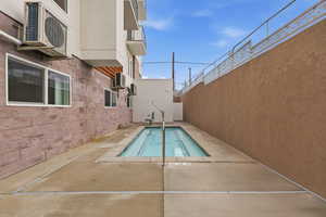 Community heated spa with a patio