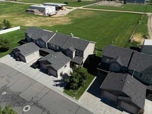Aerial perspective of townhouse (left of the tree) and view of open field behind the townhouse.