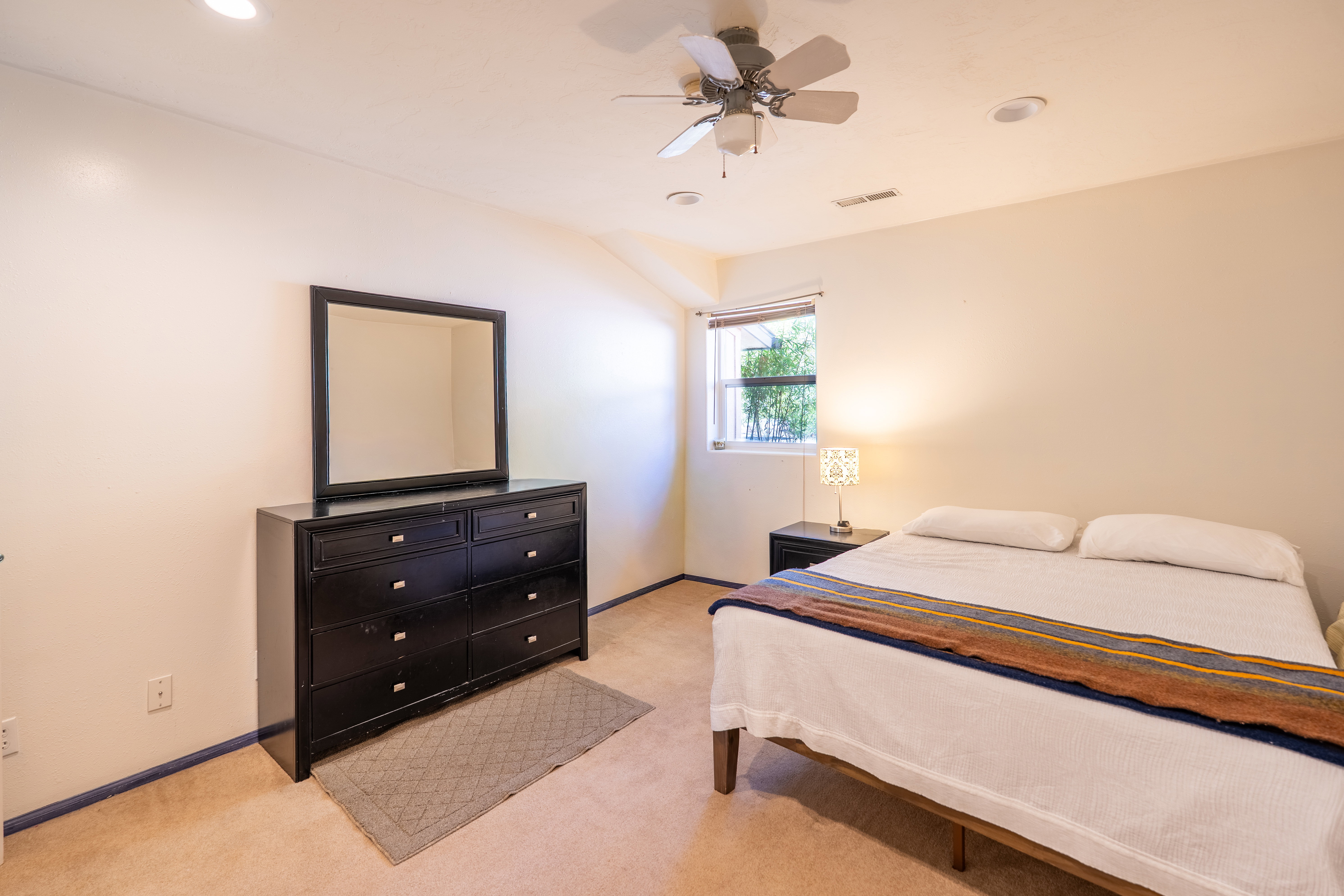 Bedroom featuring light carpet, a ceiling fan, and recessed lighting