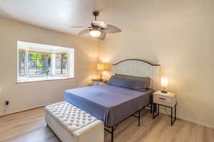 Bedroom with light wood-style flooring and ceiling fan
