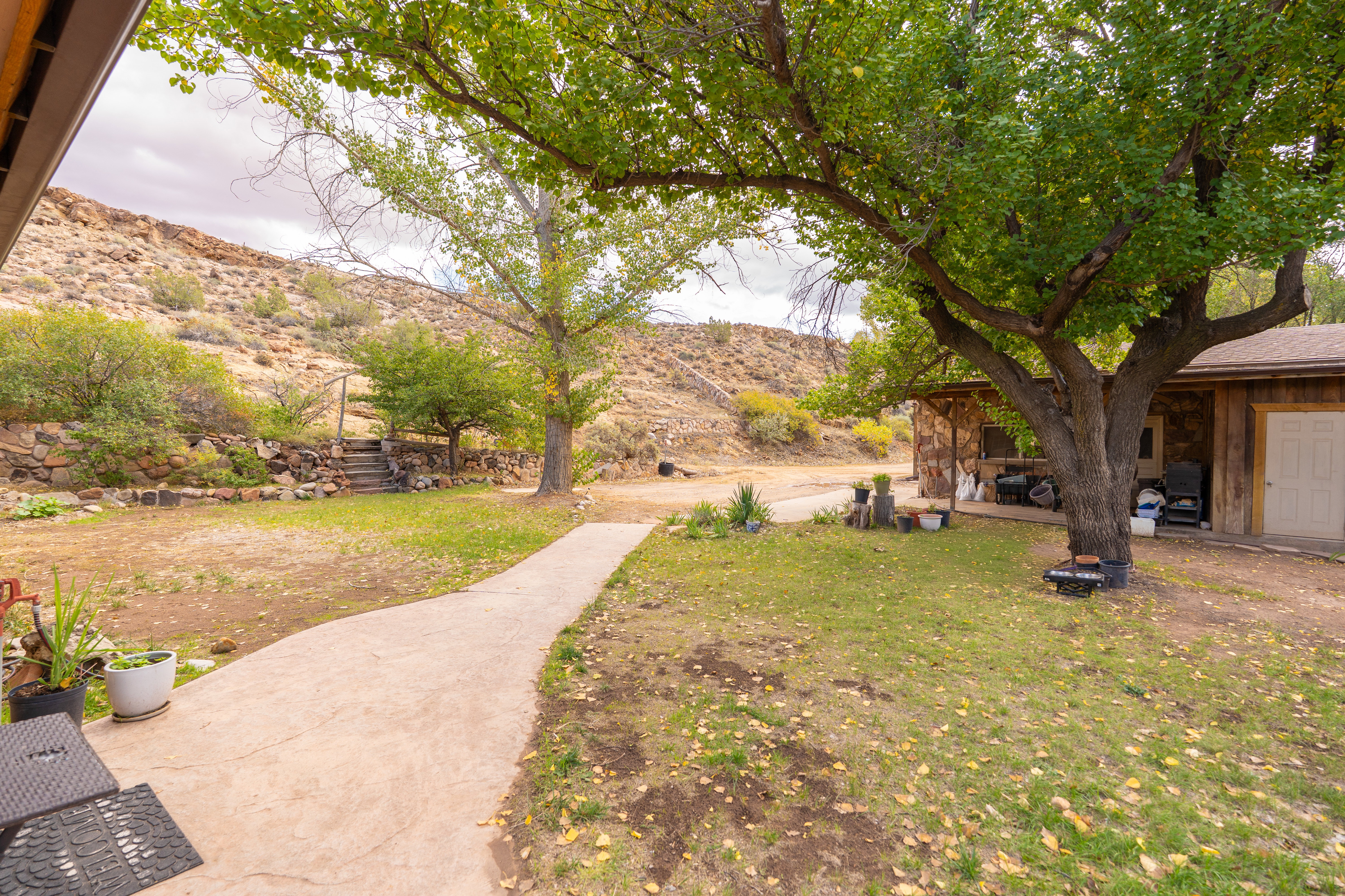 View of grassy yard with a deck with mountain view