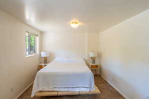Bedroom with dark tile patterned flooring and baseboards