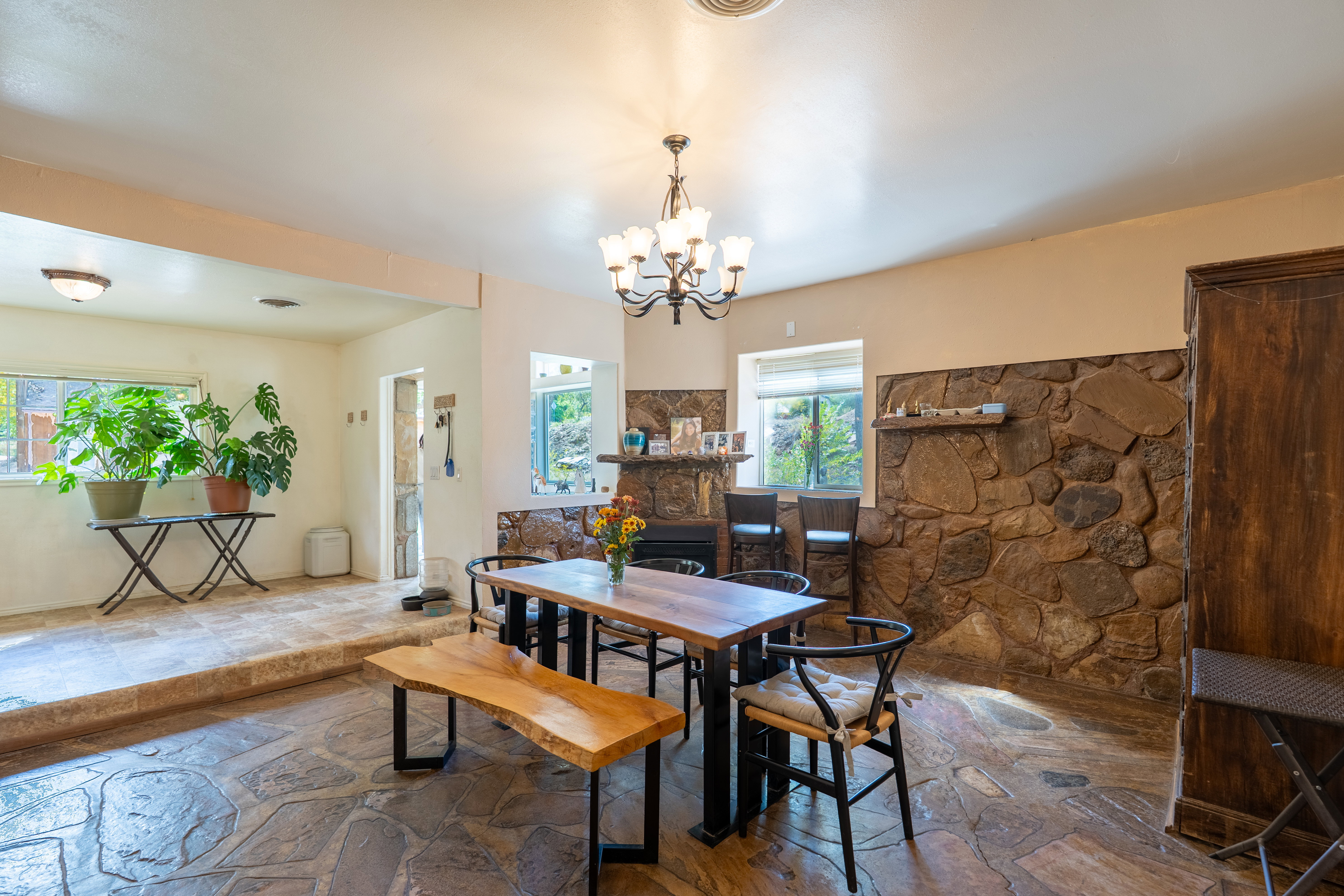 Dining area featuring stone floors and a chandelier