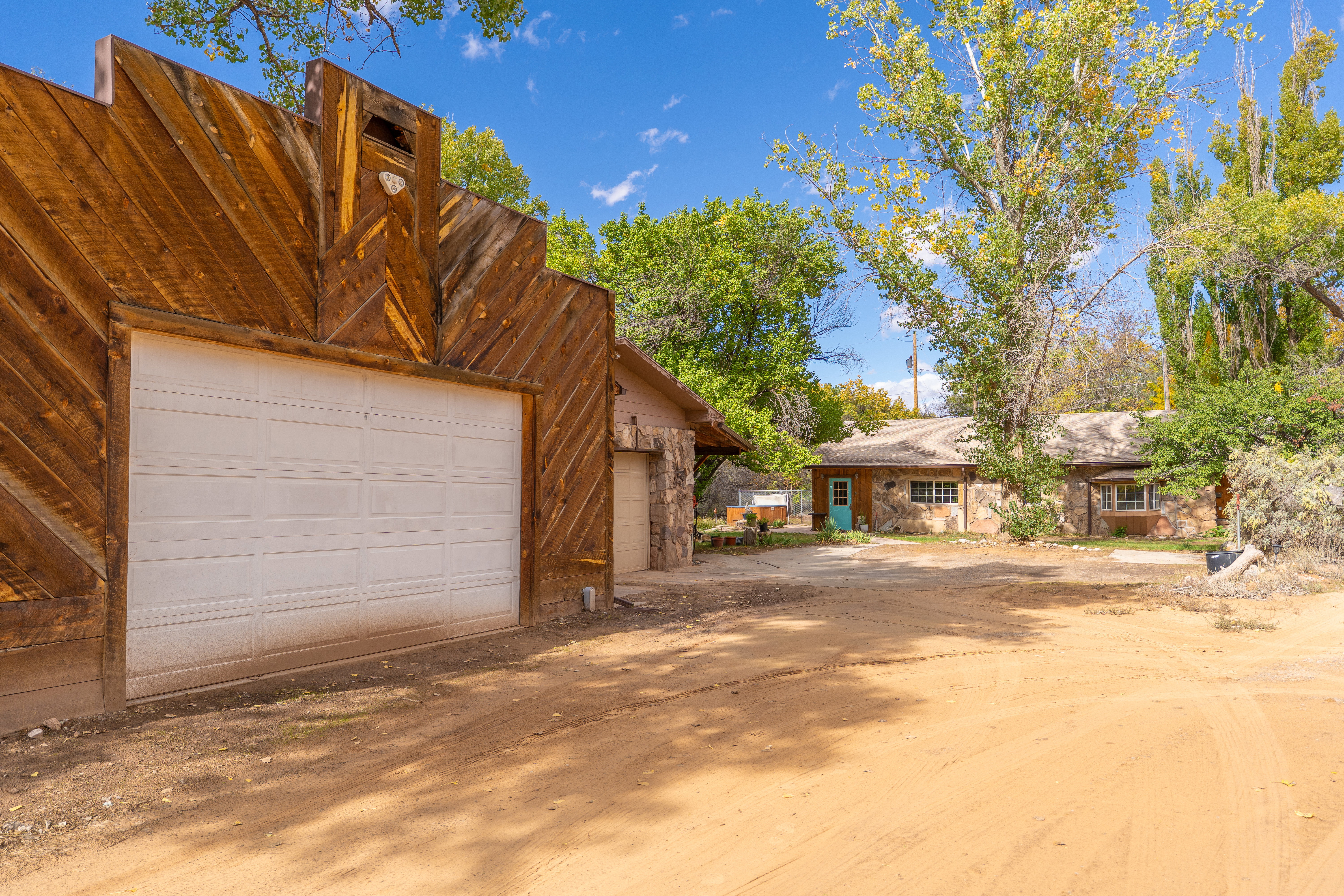View of front of house with a garage and an outdoor structure