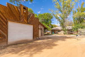 View of front of house with a garage and an outdoor structure