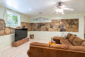 Living area with wood finished floors, recessed lighting, and a ceiling fan