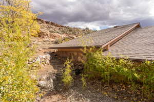 View of property exterior featuring a shingled roof