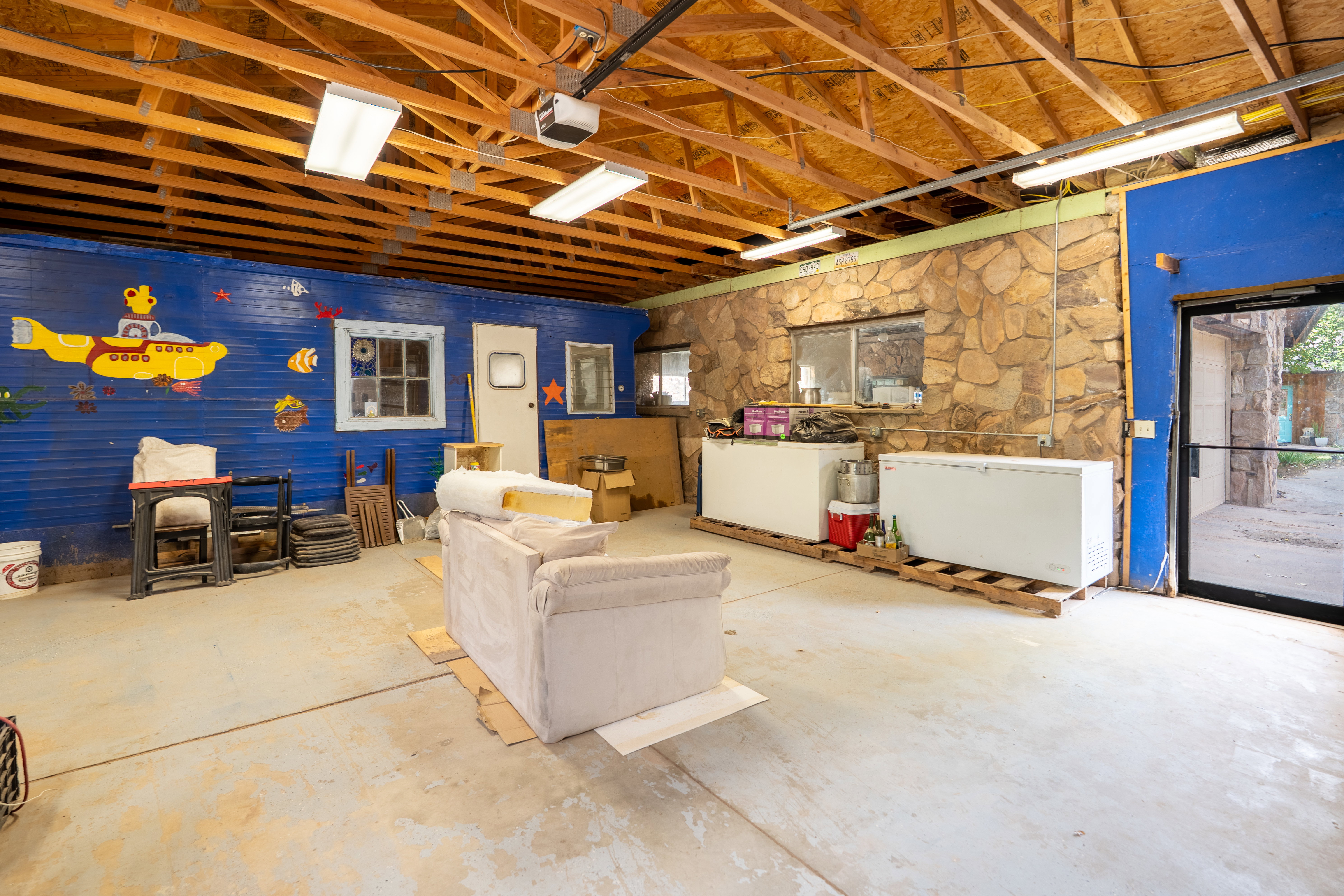 Below grade area featuring a garage and fridge