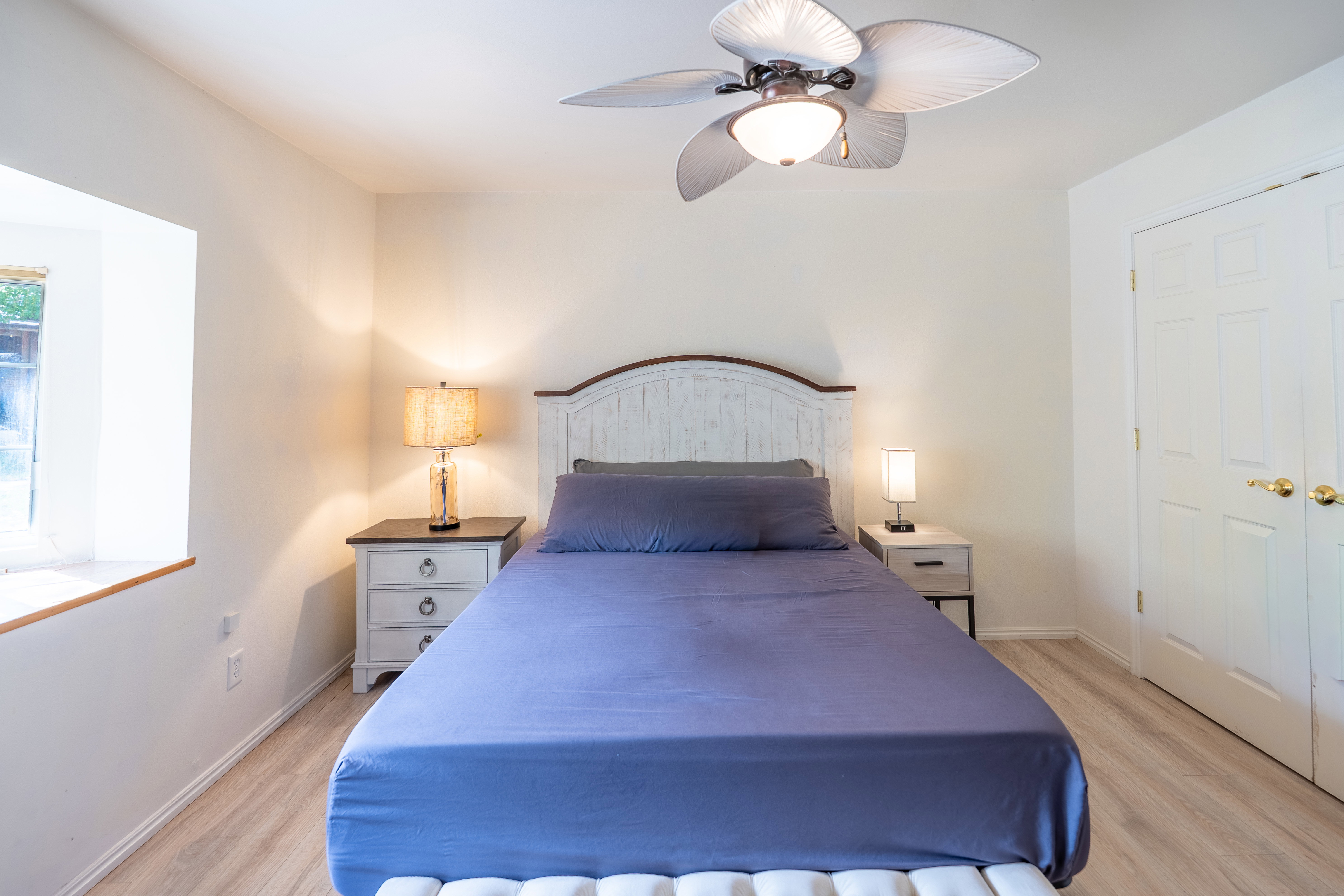 Bedroom featuring light wood-style flooring and a ceiling fan