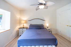 Bedroom featuring light wood-style flooring and a ceiling fan