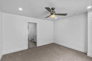 Unfurnished bedroom with light colored carpet, ensuite bath, a ceiling fan, and recessed lighting