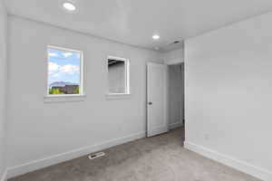 Unfurnished bedroom featuring carpet and recessed lighting