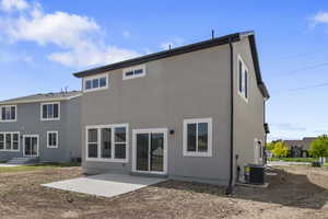 Rear view of house with a patio and stucco siding