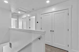 Hallway featuring recessed lighting and carpet floors