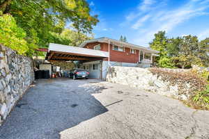 View of front of house featuring asphalt driveway and brick siding
