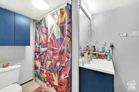 Full bath with vanity, a shower with curtain, and tile patterned flooring