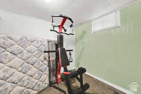Exercise room with a drop ceiling and carpet