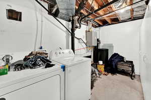 Laundry area featuring unfinished concrete flooring and separate washer and dryer