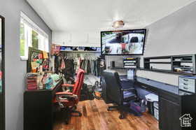 Office featuring dark wood-type flooring and a textured ceiling