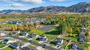 Aerial view of property's location with nearby suburban area and a mountain backdrop