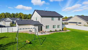 Rear view of house with a patio, a fenced backyard, a residential view, and a shingled roof