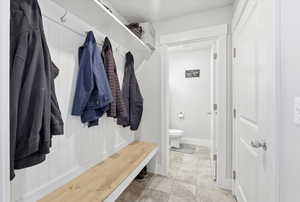Mudroom with light tile patterned flooring
