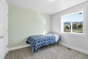 Bedroom with carpet floors and a mountain view