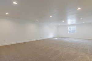 Spare room featuring recessed lighting and light carpet