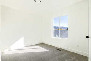 Empty room with carpet and a mountain view
