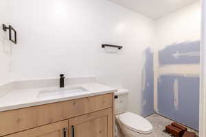 Bathroom featuring vanity and toilet