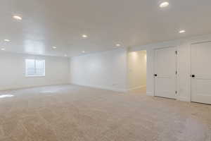 Below grade area with recessed lighting and light carpet